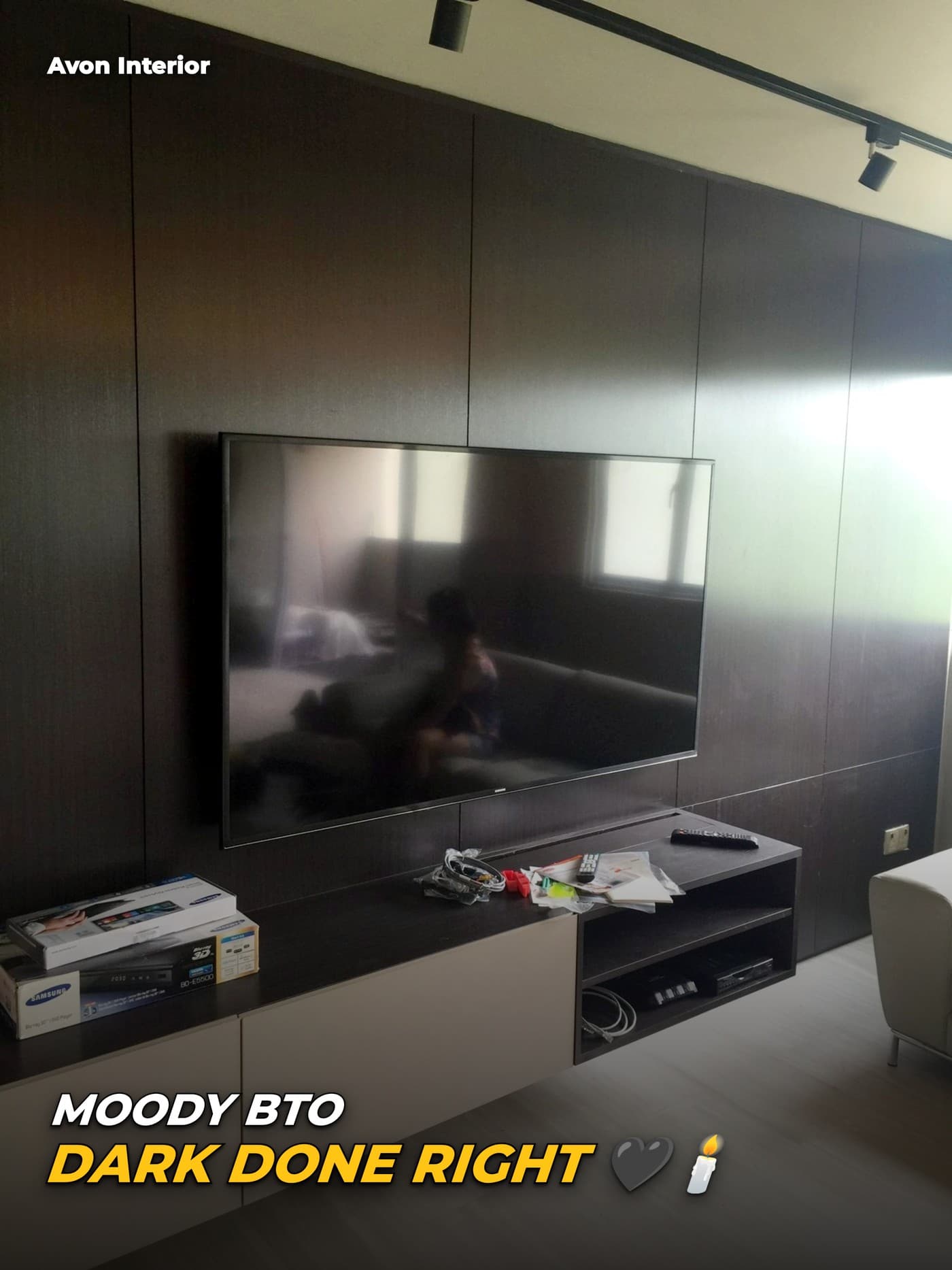 Ang Mo Kio living room with dark panelled TV wall. Headline on the image: Moody BTO, dark done right