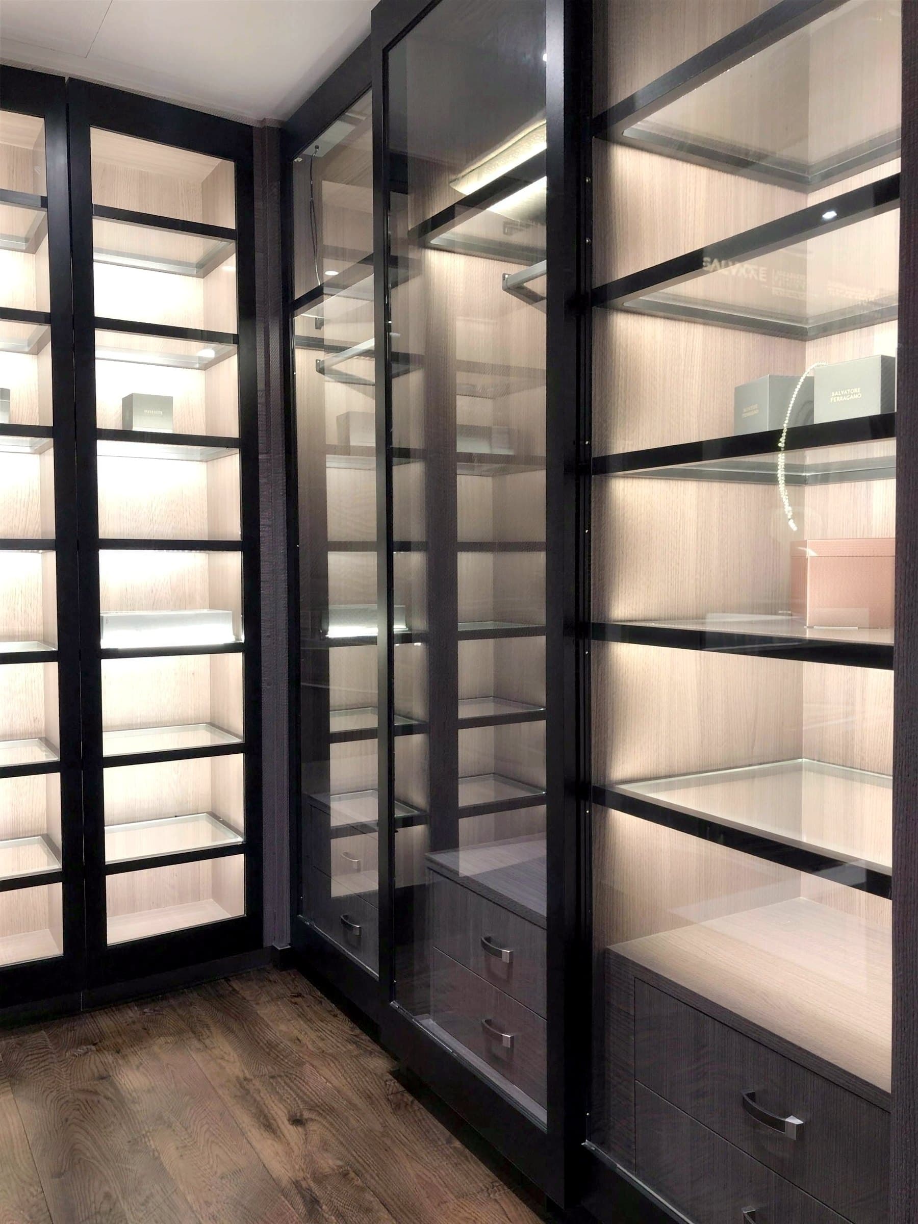 Built-in wardrobe run with backlit glass display shelves