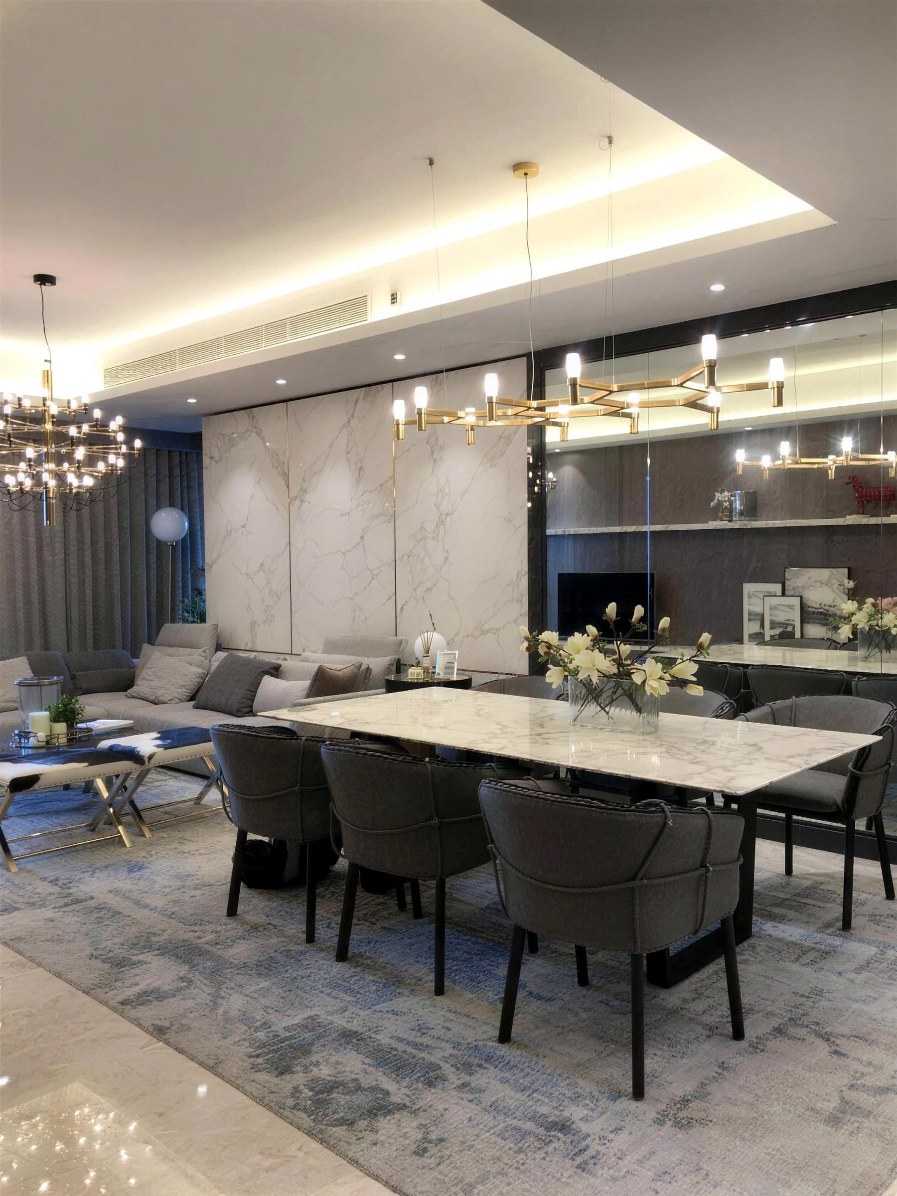 Dining area with a full-height mirror wall and cove lighting