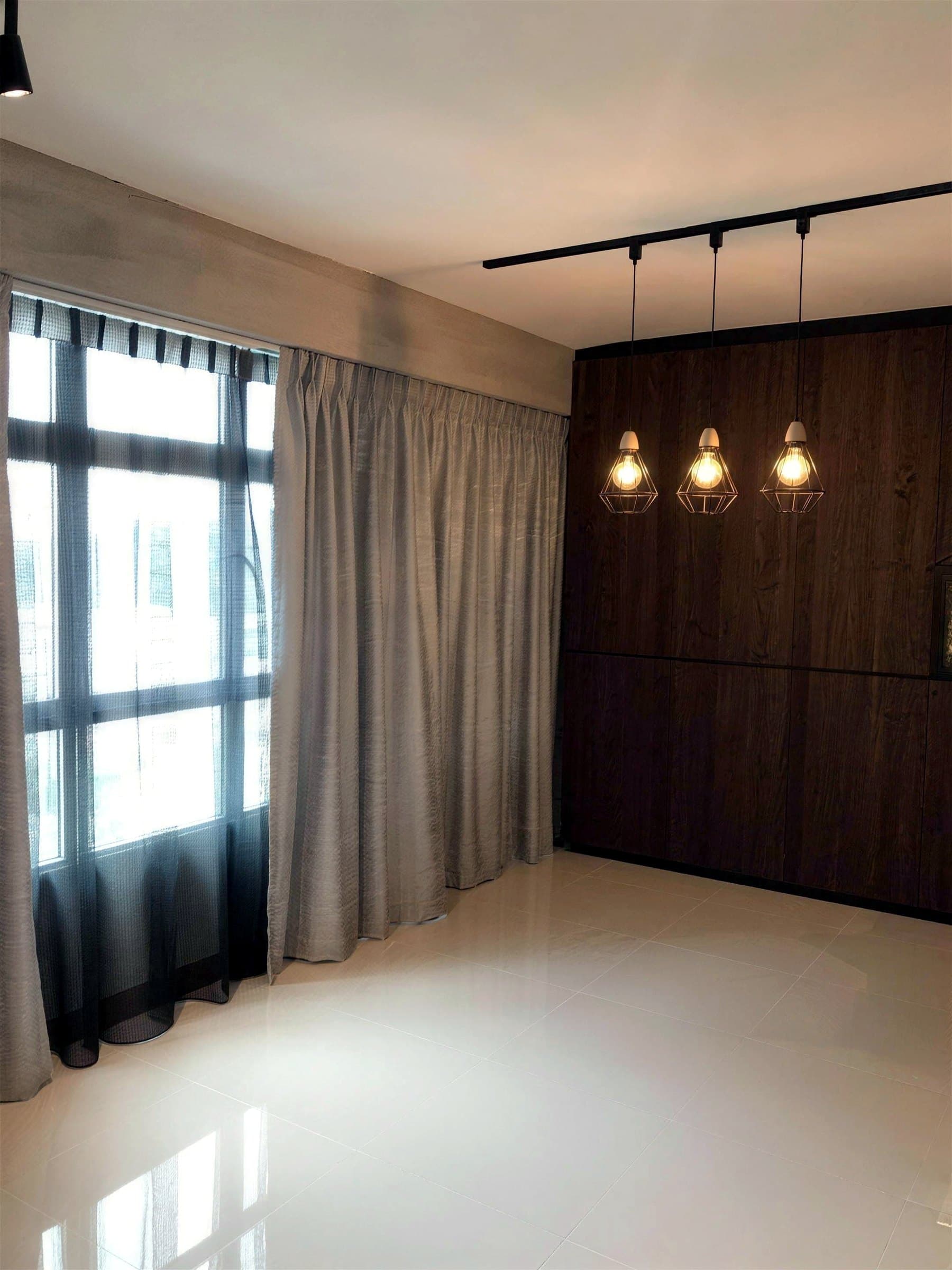 Living room with exposed track lighting and curtains