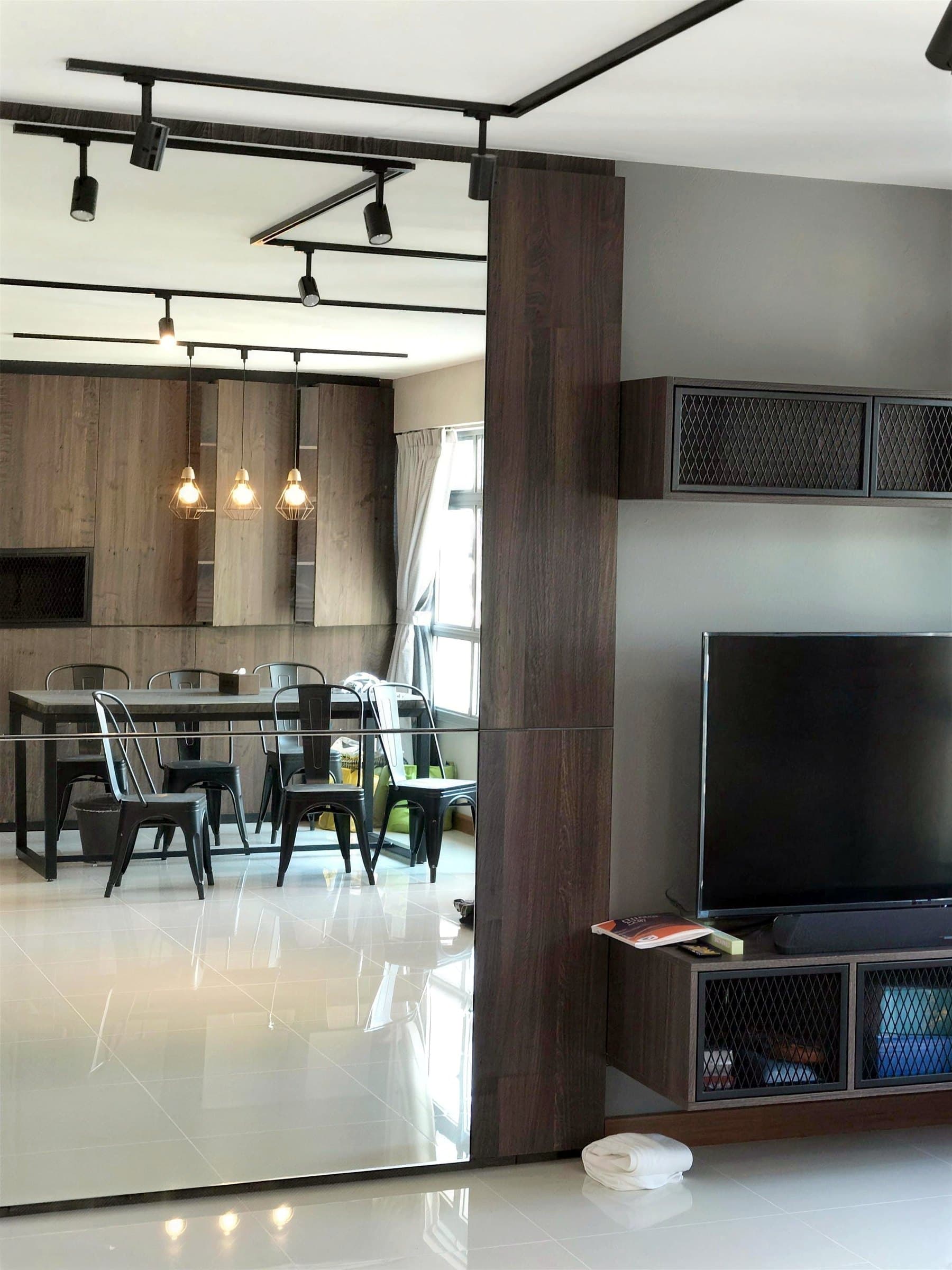 Living room with television wall and full-height mirror