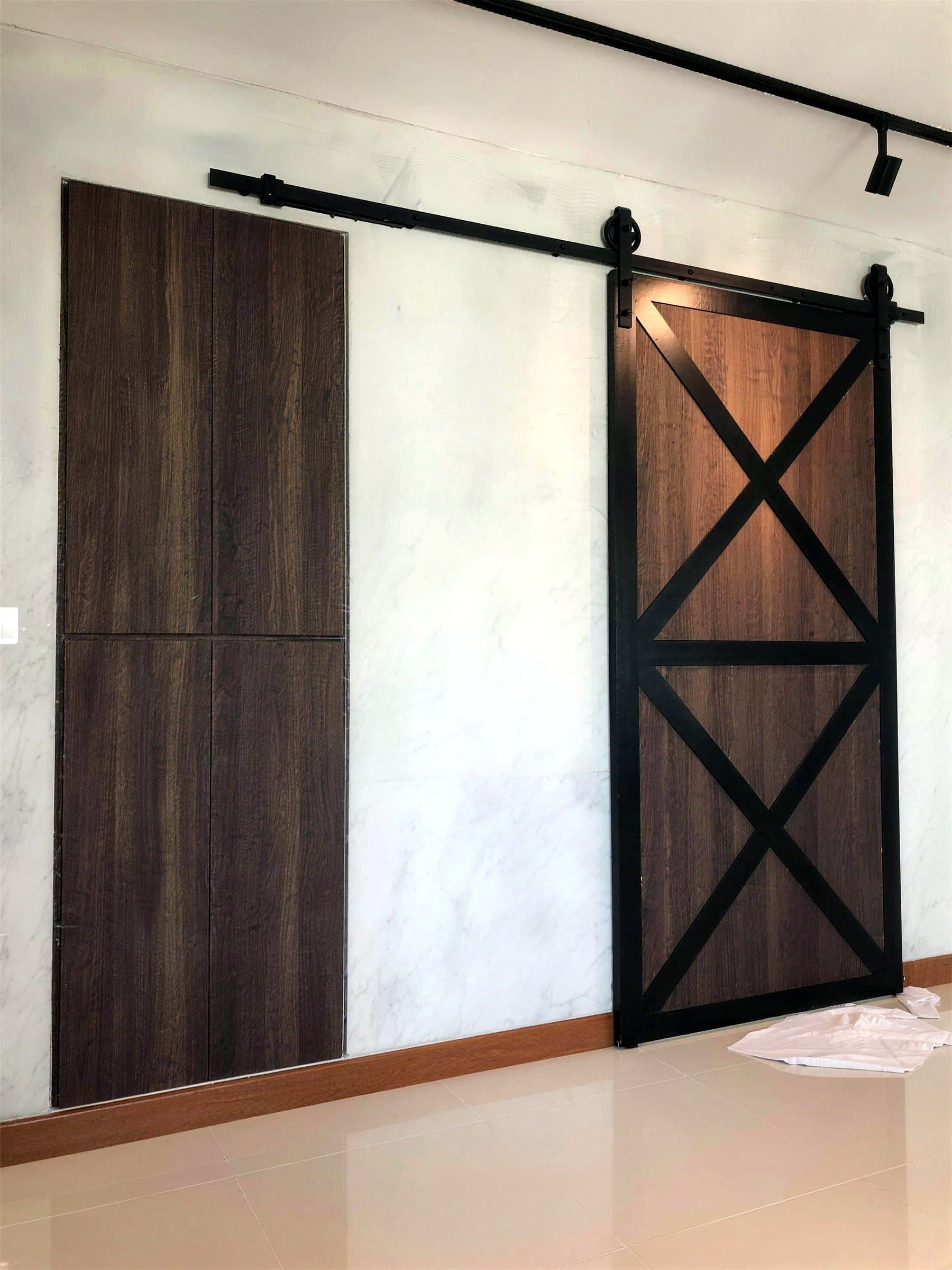 Sliding timber barn door on black track