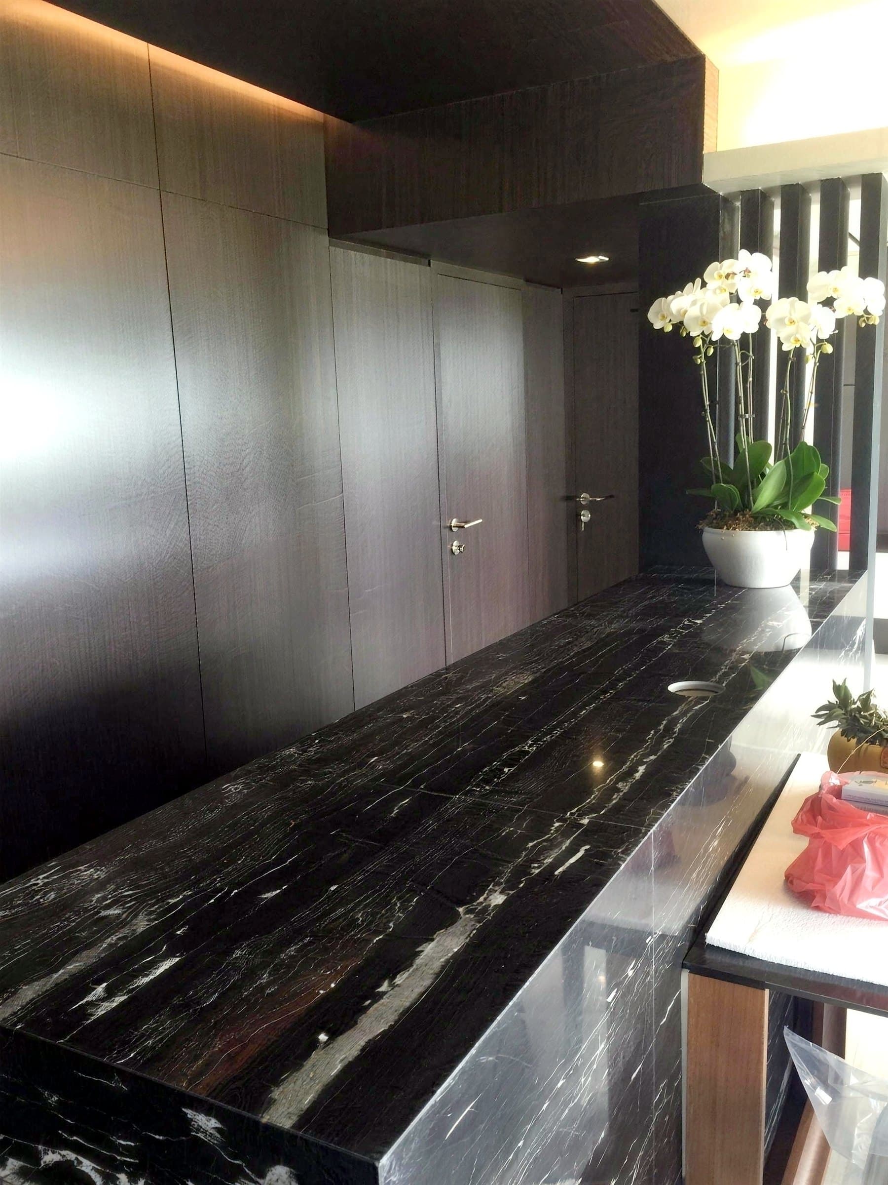 Dark stone-look entry counter with waterfall edges