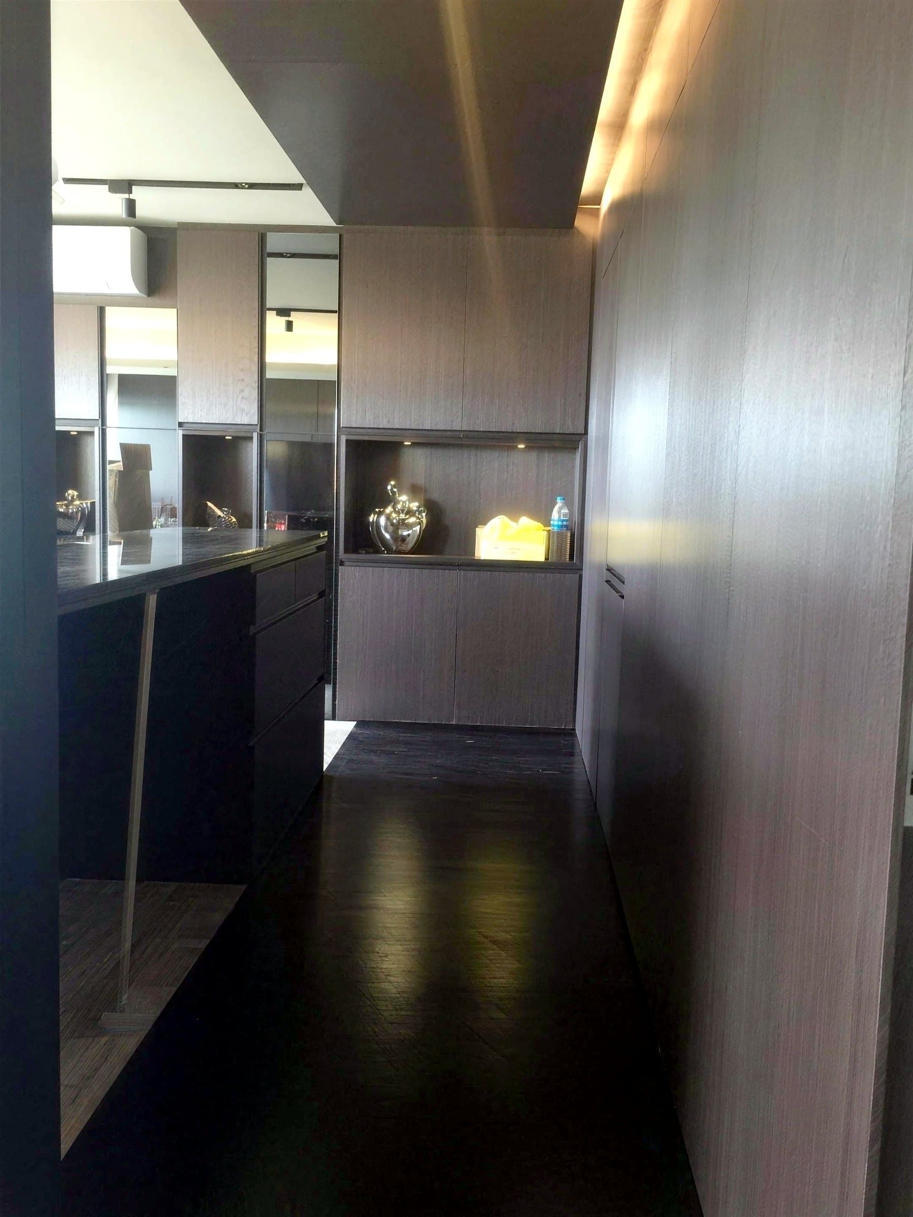 Corridor with concealed cove lighting and lit display niches