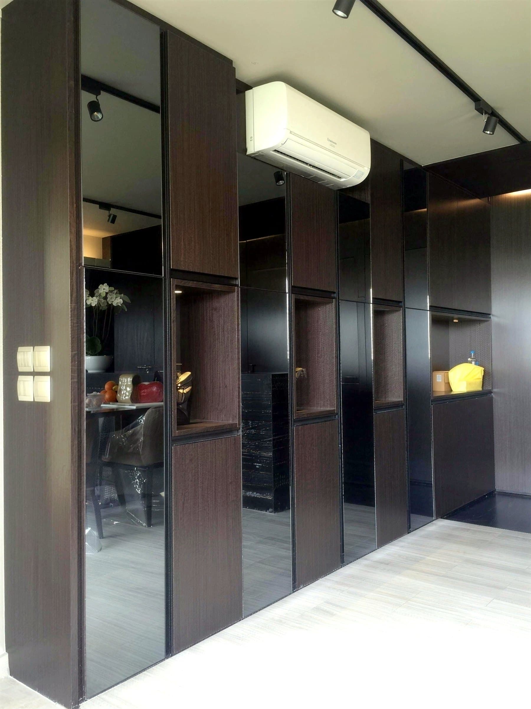 Mirrored wardrobe doors set in dark wenge panels