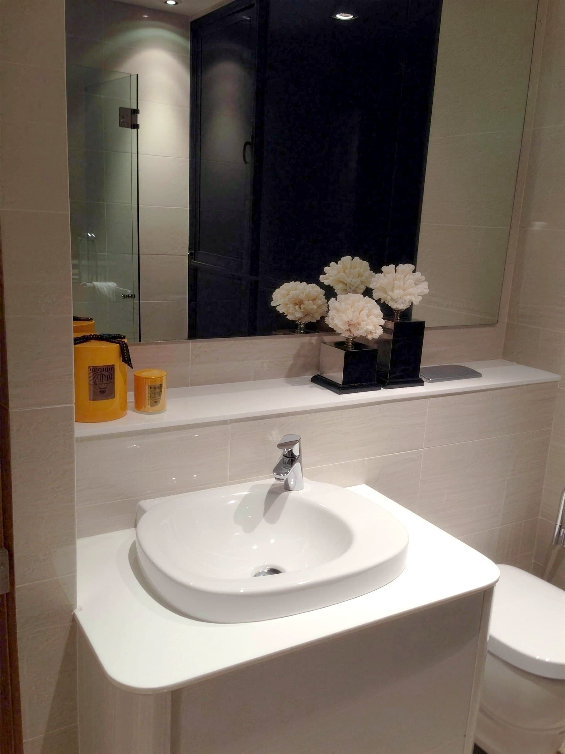 Bathroom vanity with countertop basin and mirror wall