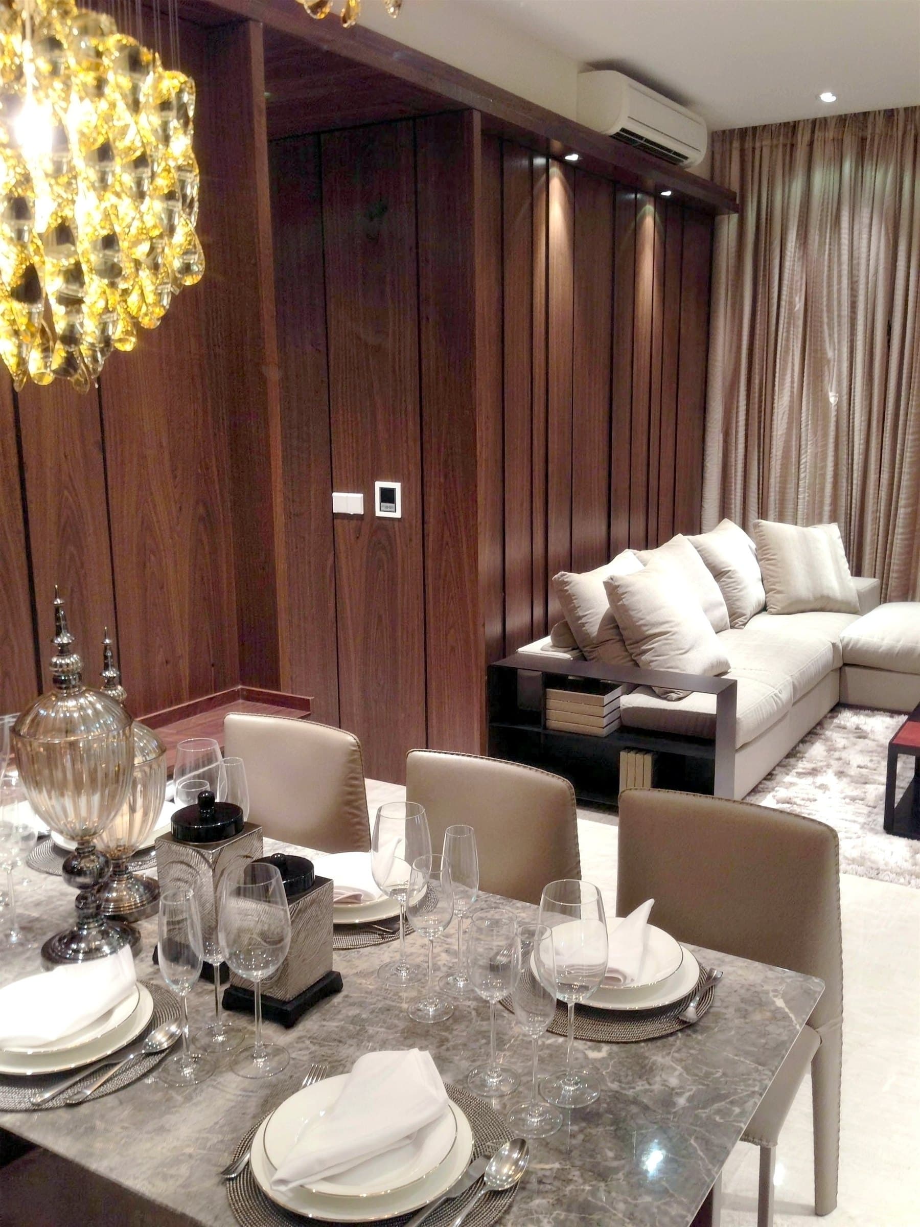 Multi-orb pendant over the dining table and walnut panelling