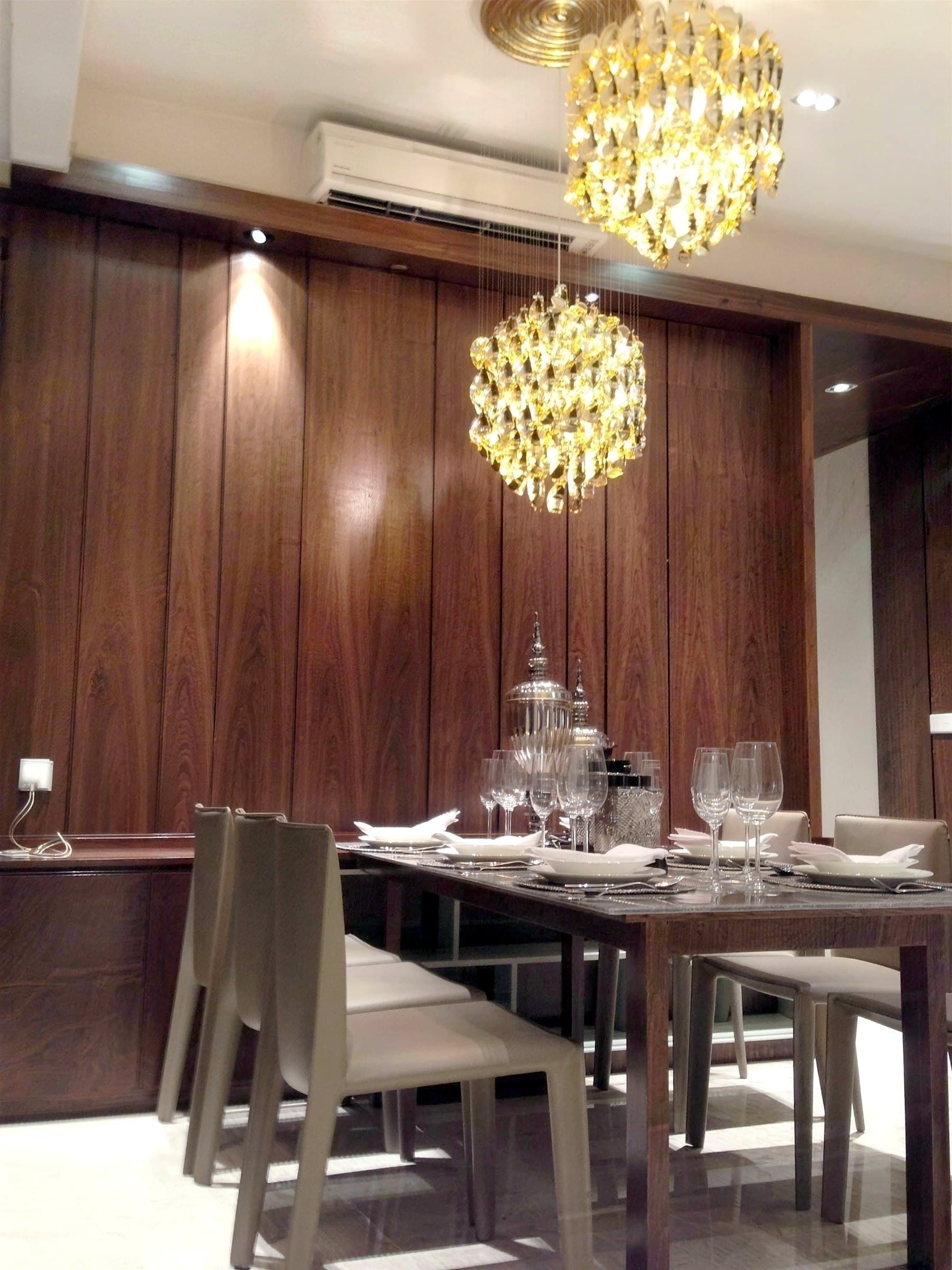 Dining area against a dark walnut panelled wall