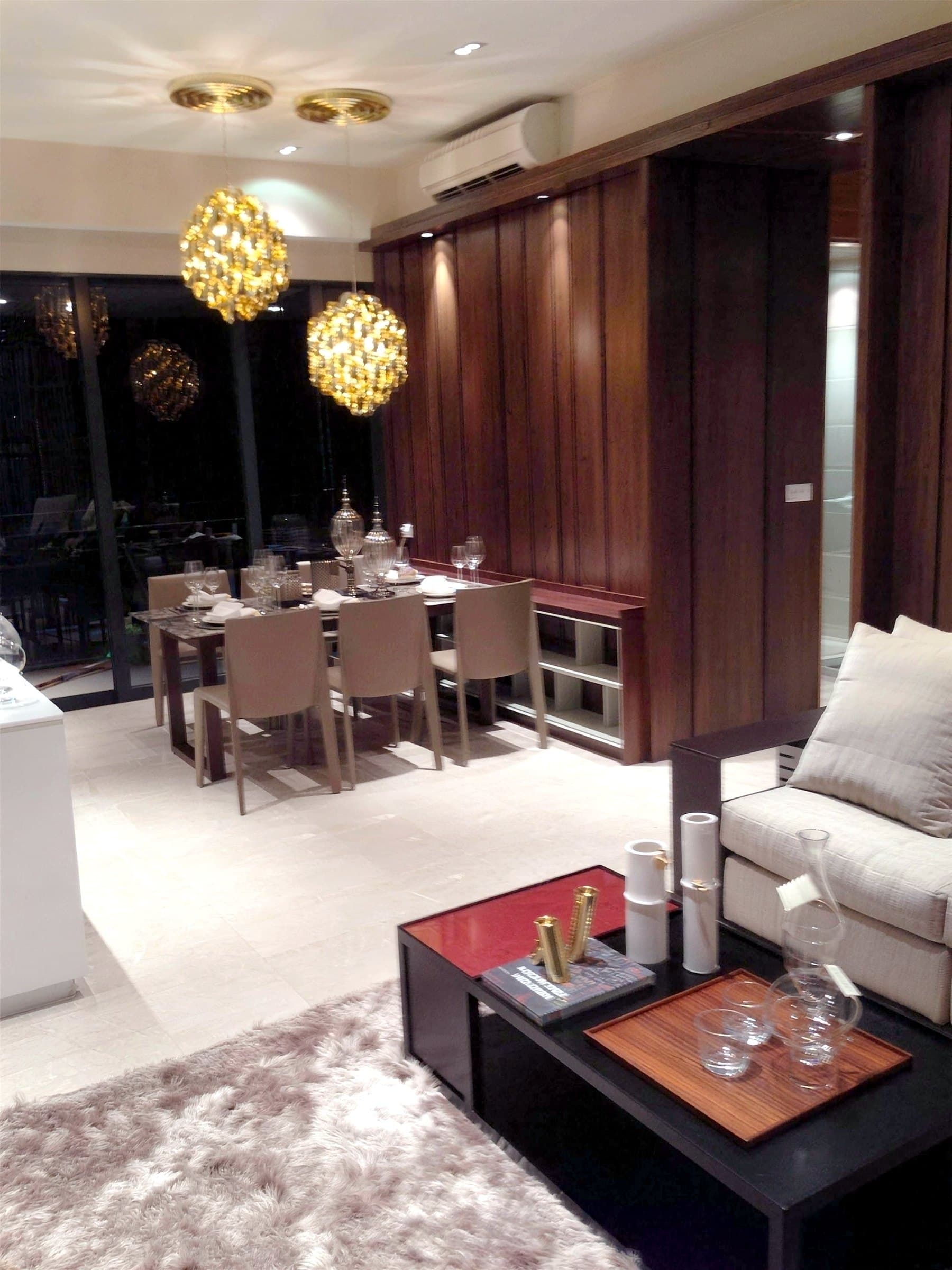 Balmoral living and dining area with a dark walnut panelled feature wall and pendant light