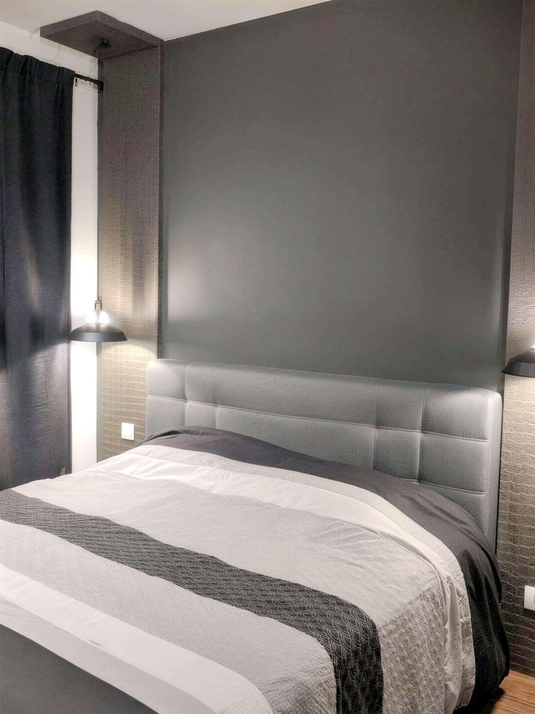 Master bedroom with charcoal feature wall, wallpaper columns and black cone reading lights