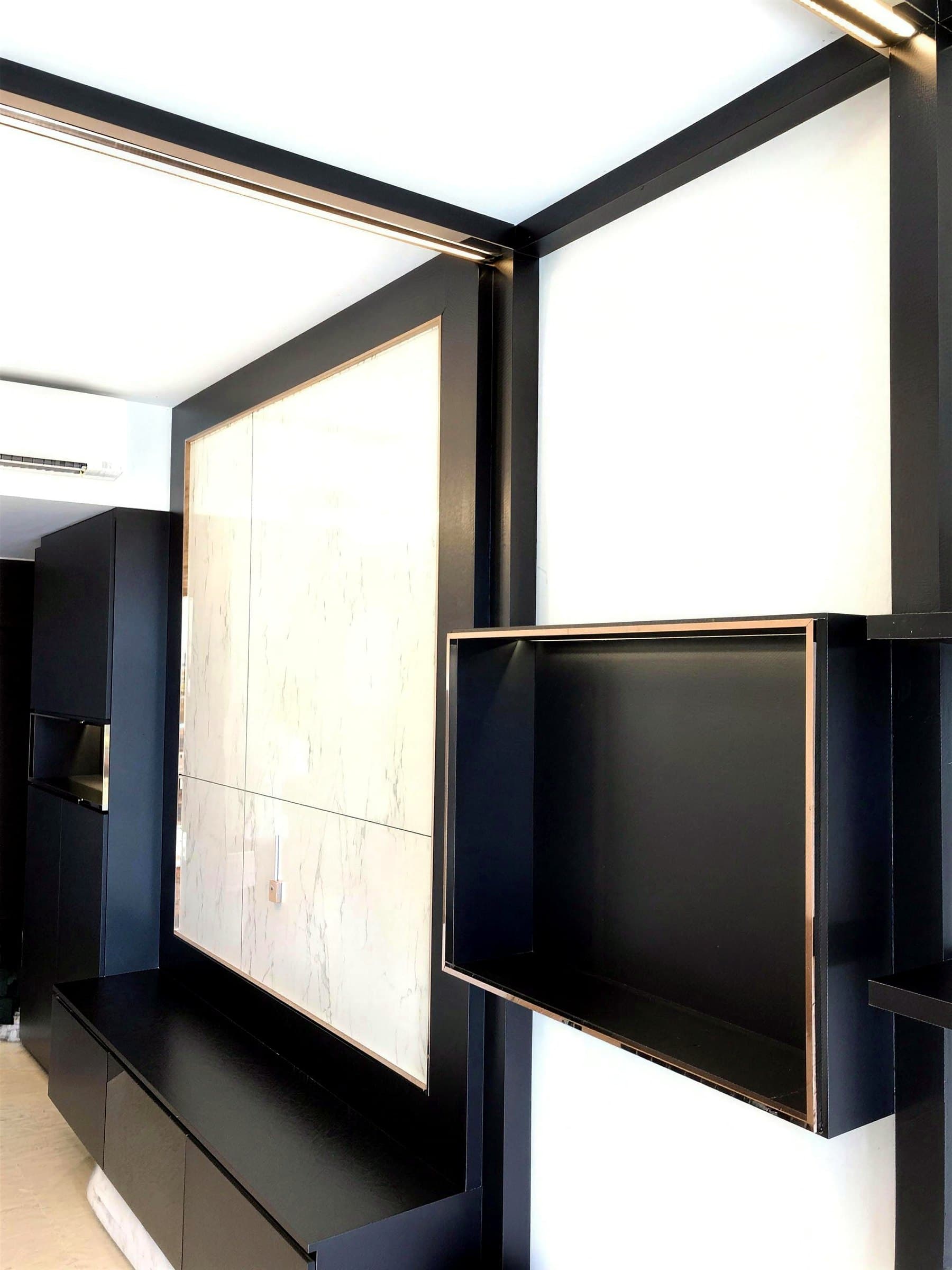 Black lacquered cabinet with rose-gold edge trim