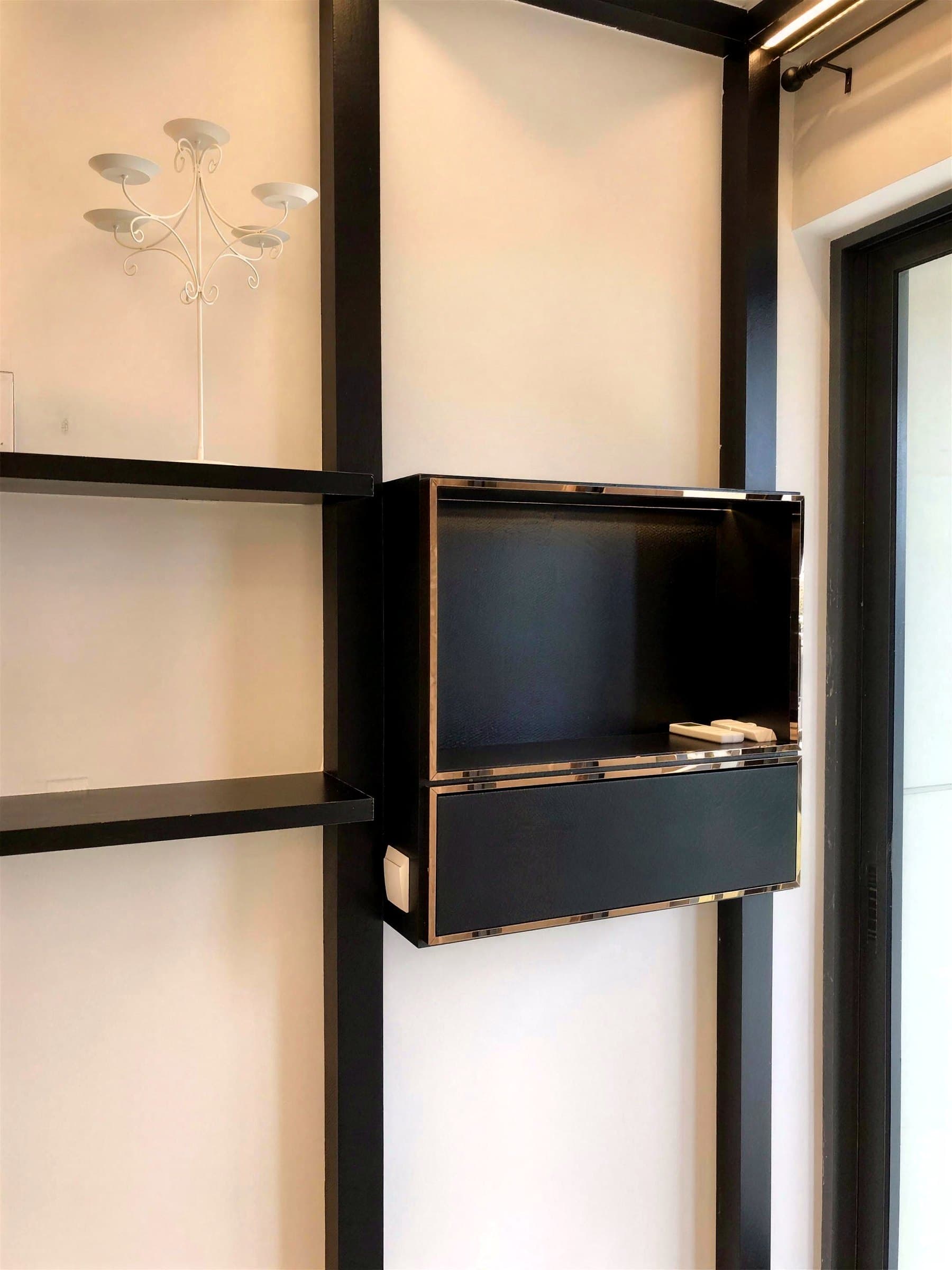 Floating black cabinets and shelves with rose-gold trim