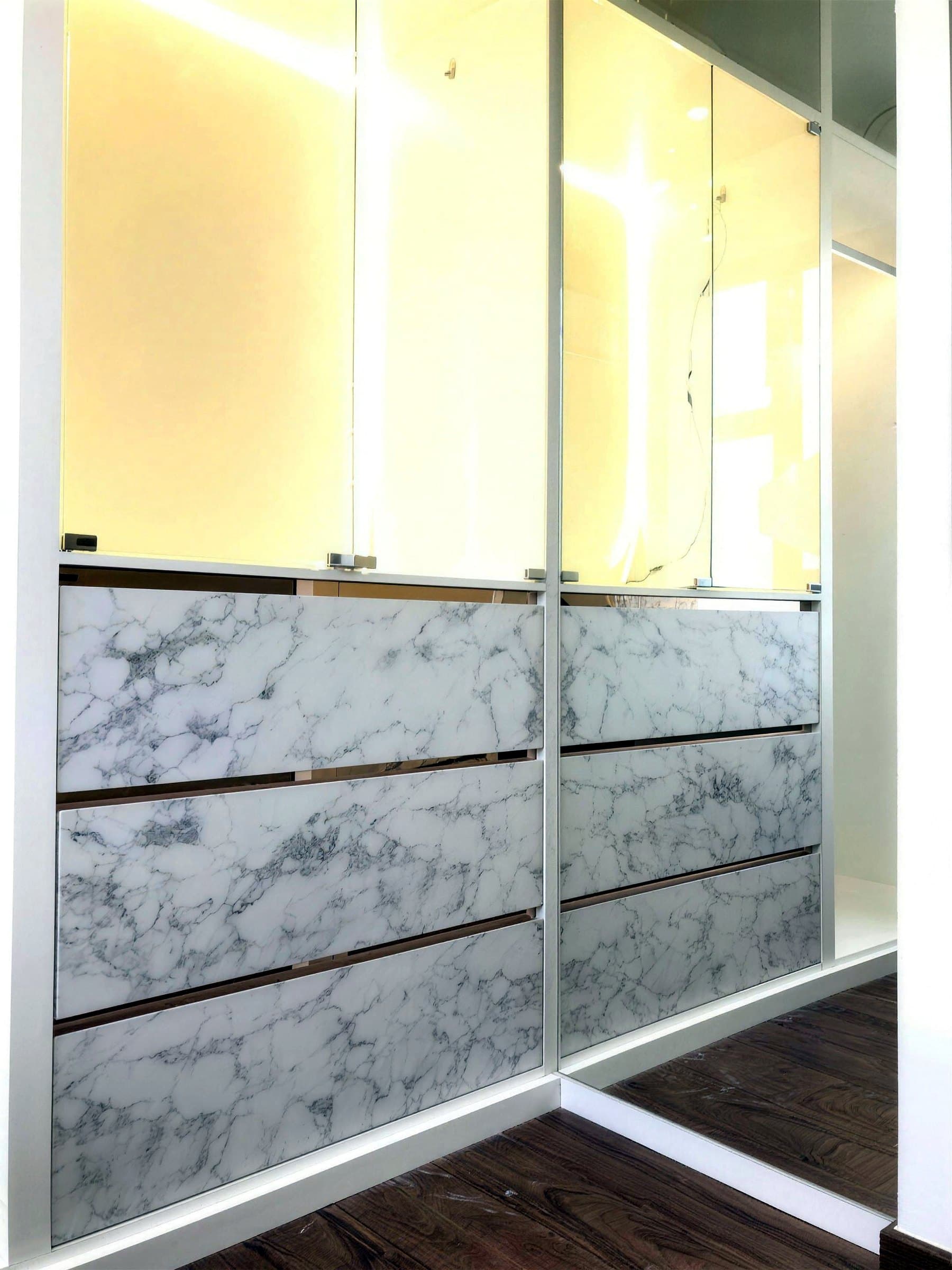 Wardrobe doors in marble-look panels with metal trims