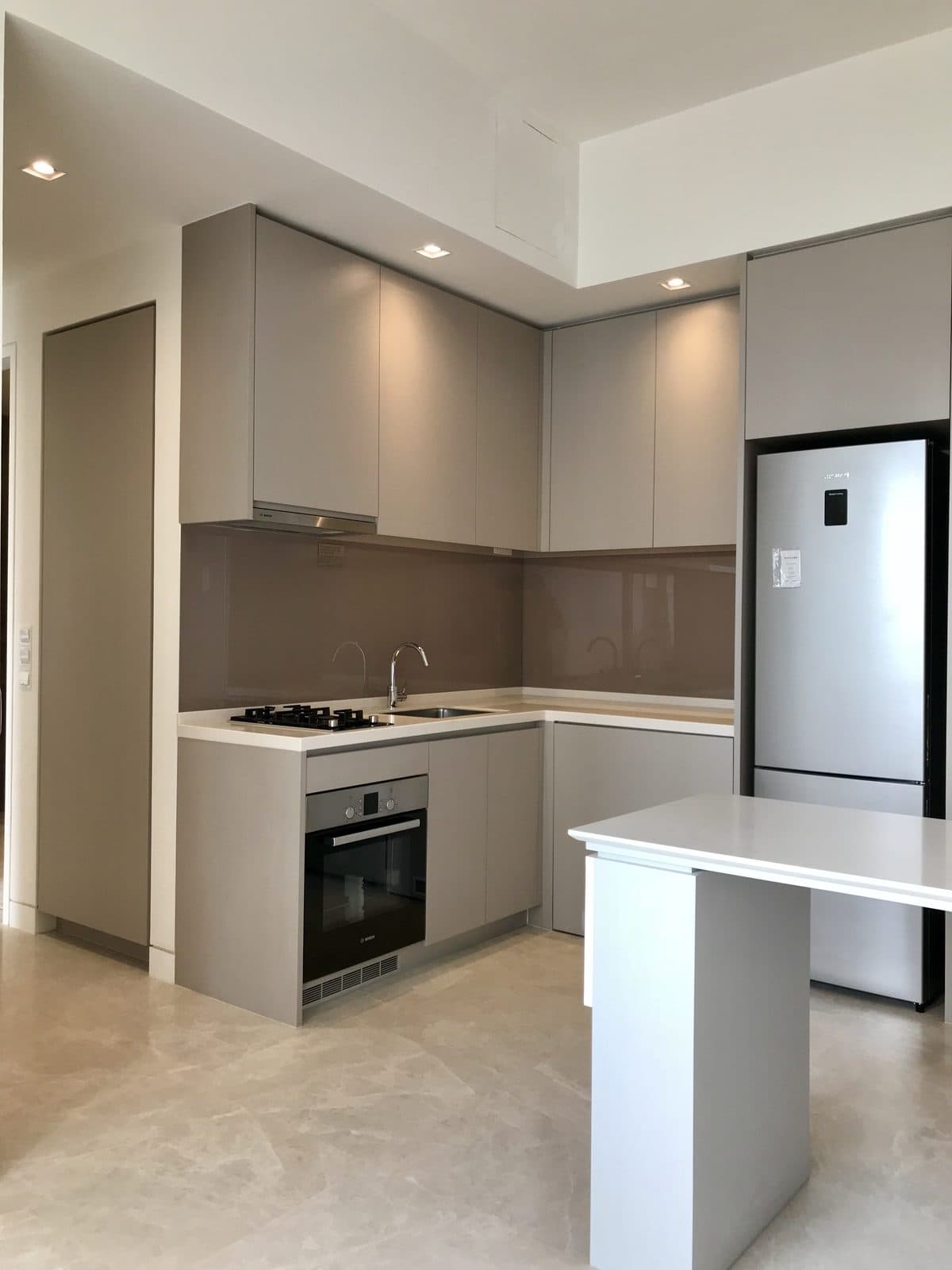 Kitchen with integrated appliances and stone countertop