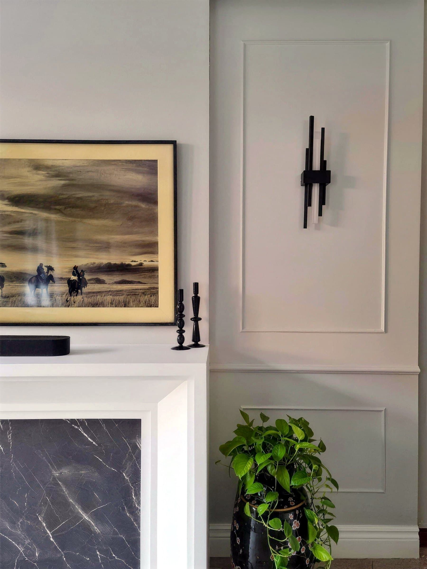 Mantel-style feature wall detail with marble-look inset and sconce