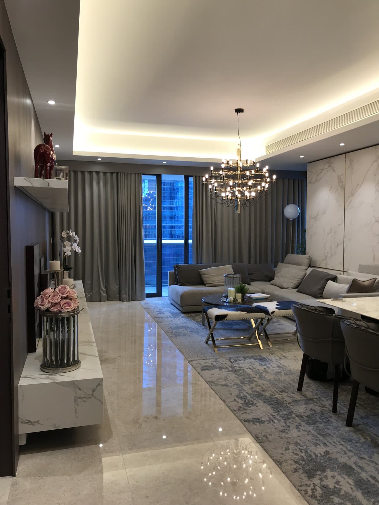 Marina Bay Suites living room with chandelier and marble accents