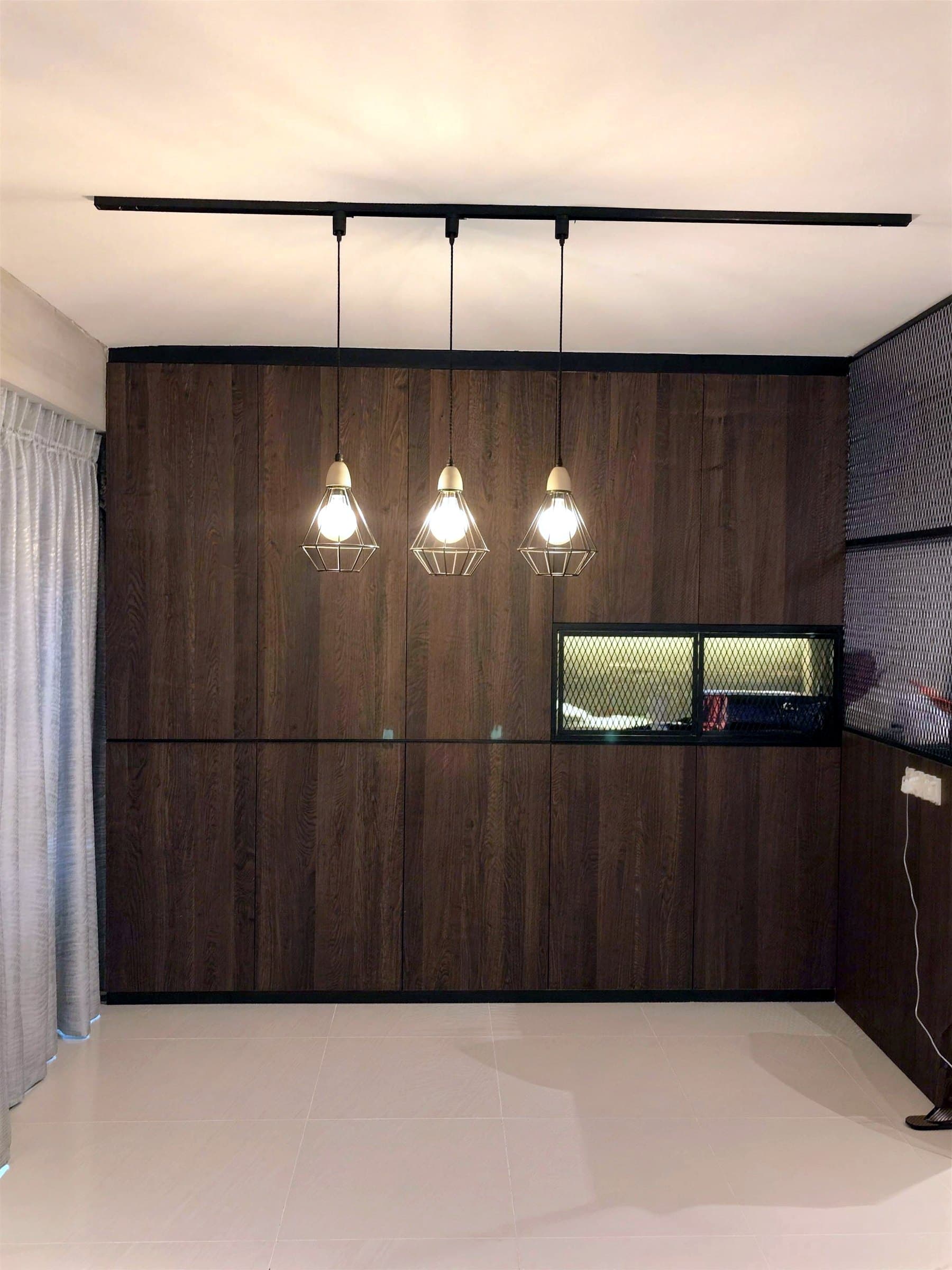 Skypeak living room with dark timber feature wall and caged pendant lights