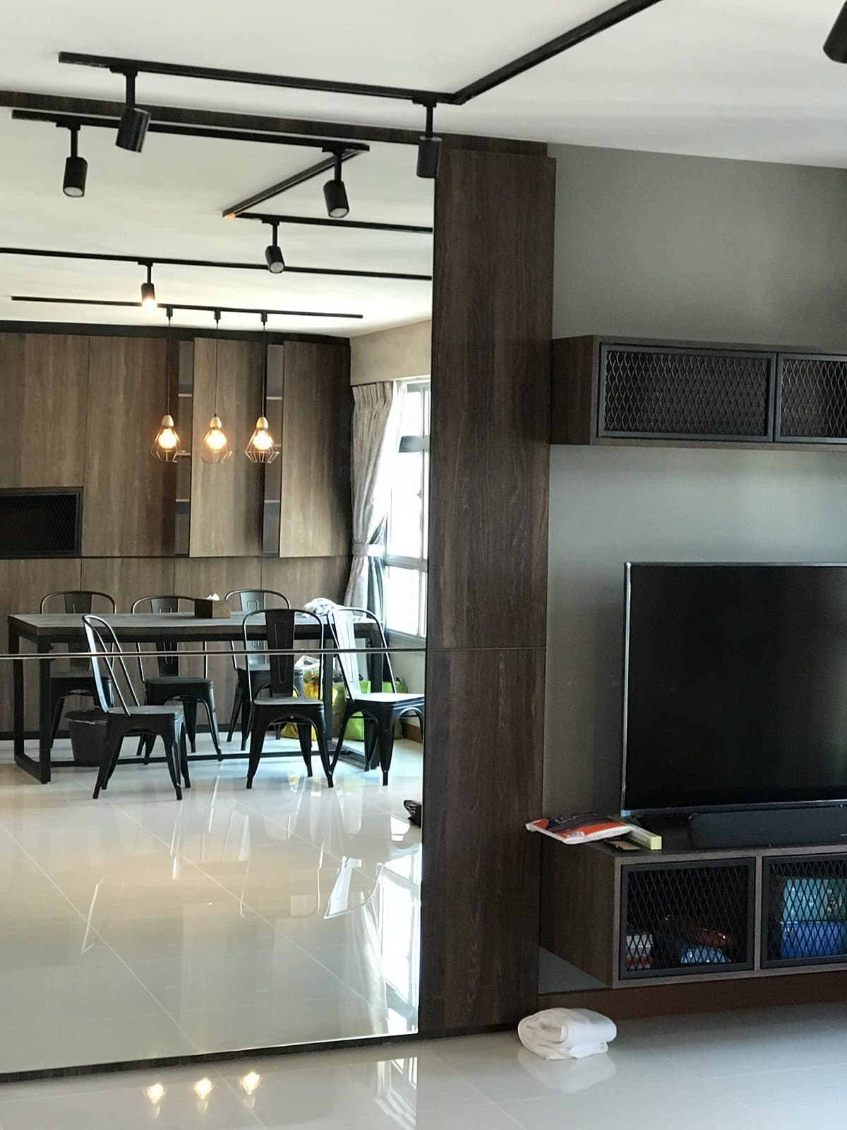 Living room with television wall and full-height mirror