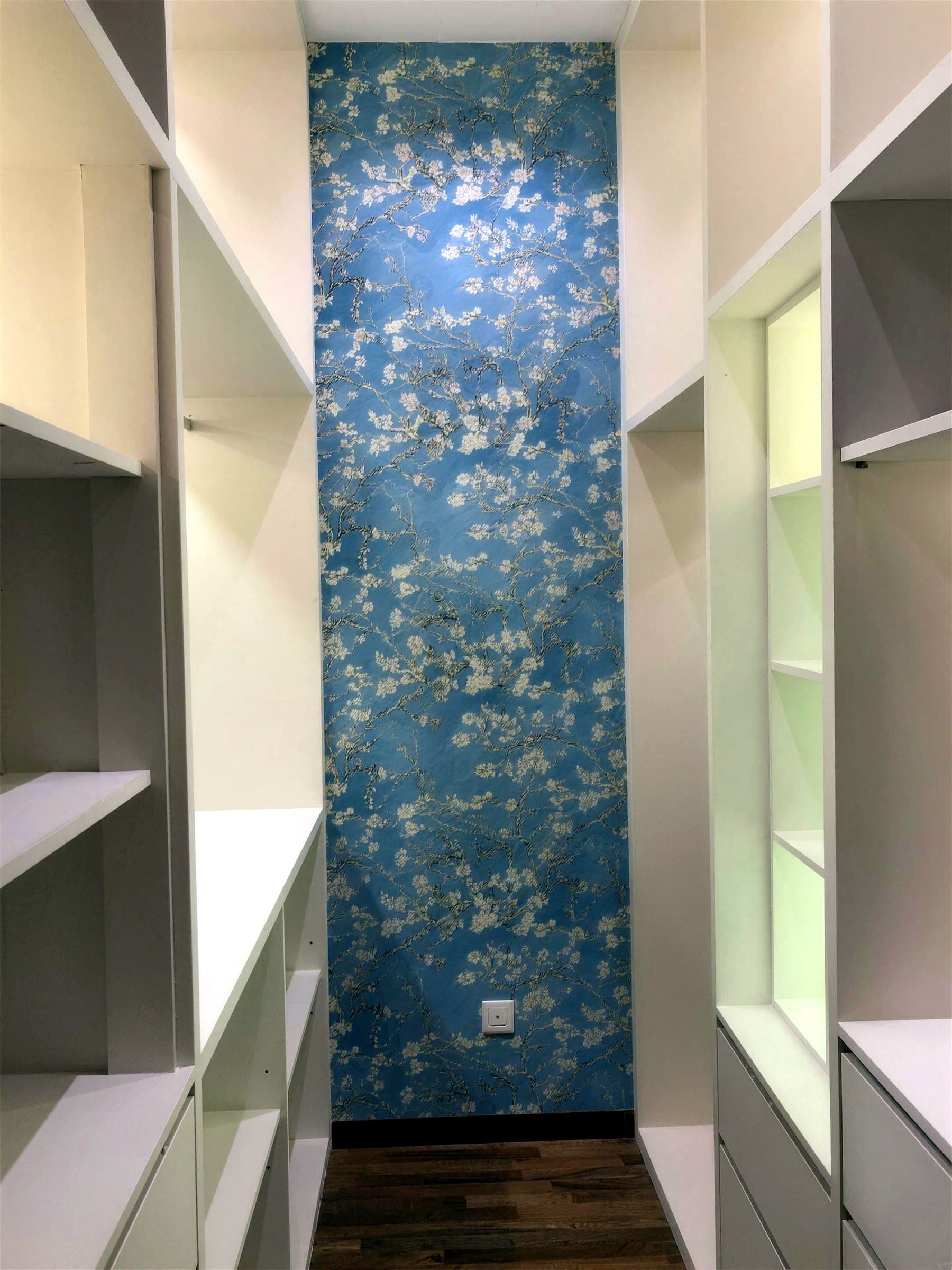 Wardrobe niche with the wallpaper continuing onto the ceiling